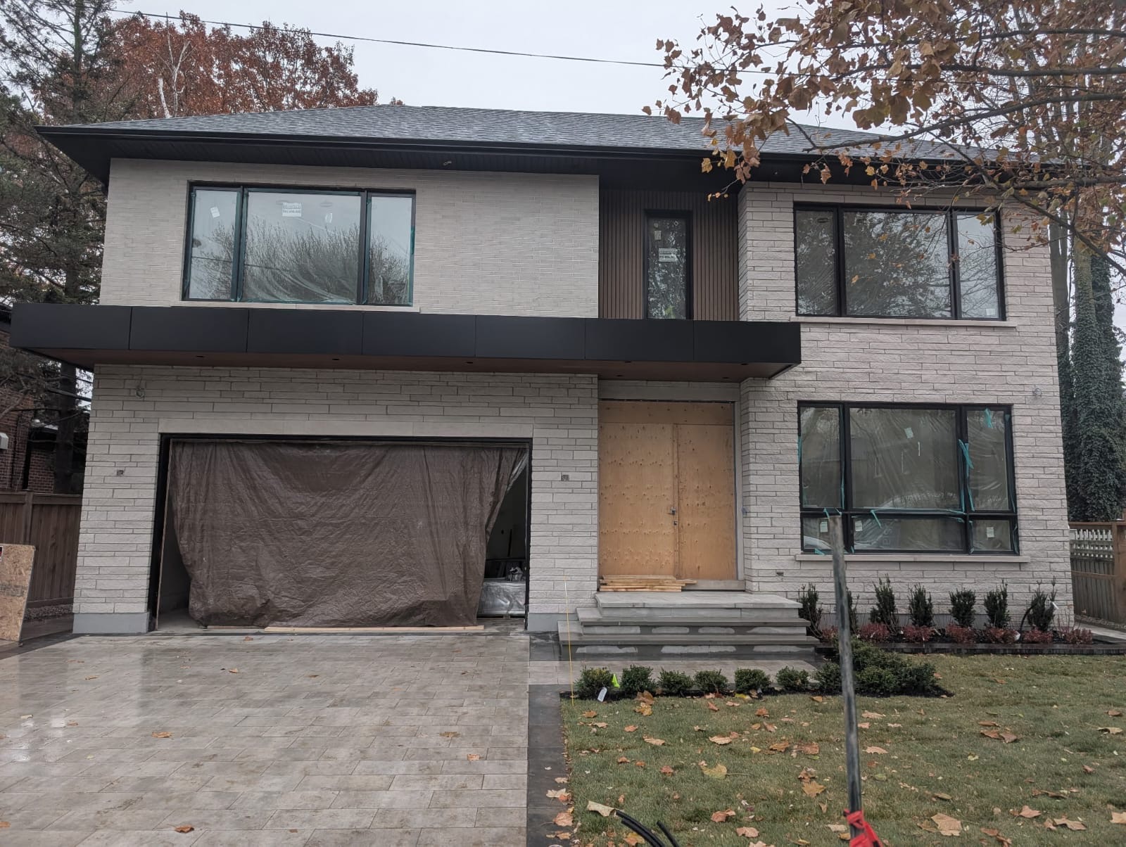 Modern two-storey home with light grey brick and contemporary facade design