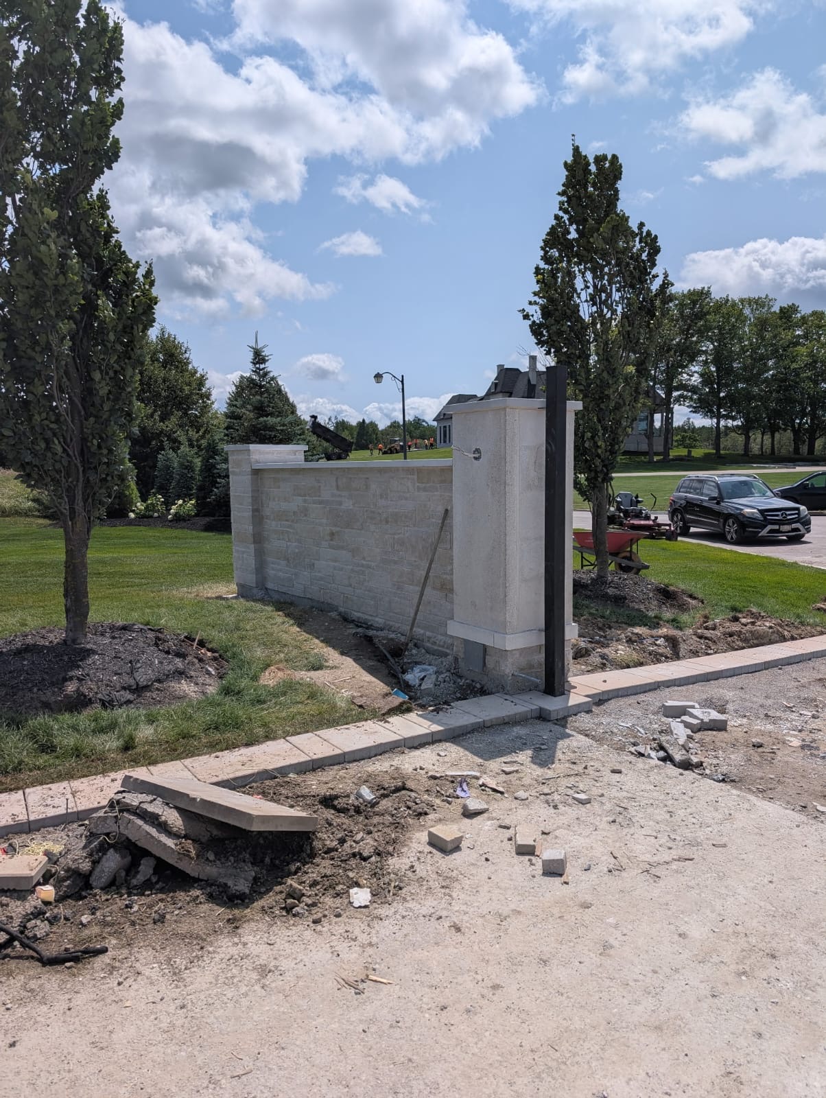 Custom stone entrance gate and privacy wall in limestone