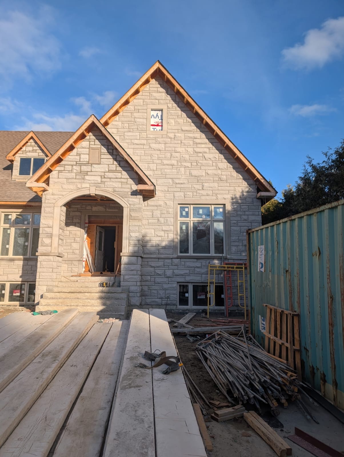 New home construction with stone exterior cladding and craftsman details
